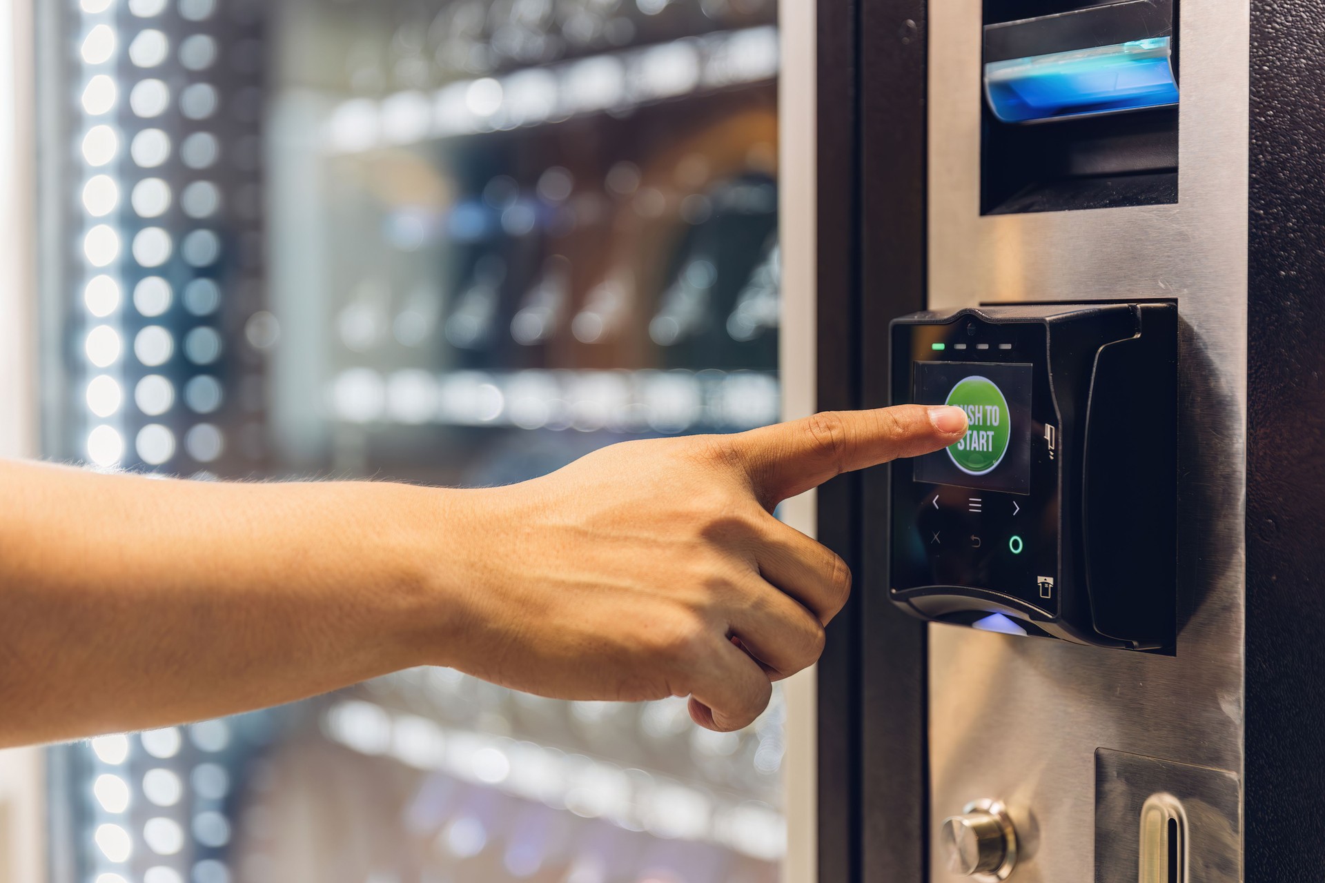 Hand man use of soft drink vending system. Man use drink coin machine at smart office or Public park. People use  Vending Machine, is robotic for the high-quality drink